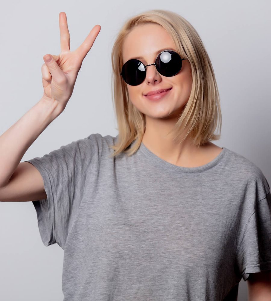 smiling-blonde-woman-in-sunglasses-on-white-backgr-MHZMJWC